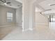 Bright, open-concept living room and stairway boasting neutral tones, tile floors, and ample natural light at 10825 Charmwood Dr, Riverview, FL 33569