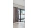 Living room with large sliding glass door to the outdoor pool area, tiled floors and curtained windows at 10825 Charmwood Dr, Riverview, FL 33569