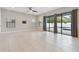 Spacious, naturally lit living room with large sliders leading to pool and backyard, ceiling fan at 10825 Charmwood Dr, Riverview, FL 33569