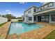 Inviting backyard pool and spa with brick pavers surround the home's outdoor living space at 10825 Charmwood Dr, Riverview, FL 33569