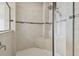 Tiled shower with a built-in bench, hand-held wand, and glass doors at 10825 Charmwood Dr, Riverview, FL 33569