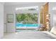 Bright bedroom with a view of the sparkling outdoor pool at 5027 Sunrise S Dr, St Petersburg, FL 33705