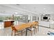 Open floor plan featuring a kitchen, dining area, living room, and unique wall art for modern living at 5027 Sunrise S Dr, St Petersburg, FL 33705