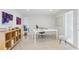 Modern office space featuring a sleek white desk and a view of the backyard at 5027 Sunrise S Dr, St Petersburg, FL 33705