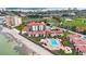 Beautiful aerial view of beachfront condos, swimming pool, and nearby golf course at 6051 Sun Blvd # 504, St Petersburg, FL 33715