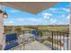 This balcony offers stunning views of the nearby golf course and features a table and chairs at 6051 Sun Blvd # 504, St Petersburg, FL 33715