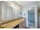 Granite counter top with dual mirrors above and a doorway leading to the shower/toilet at 6051 Sun Blvd # 504, St Petersburg, FL 33715