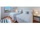Bright bedroom featuring two twin beds, tile floors, and a sunny window view at 6051 Sun Blvd # 504, St Petersburg, FL 33715