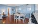 Comfortable dining area featuring a white table and chairs next to breakfast bar and living area at 6051 Sun Blvd # 504, St Petersburg, FL 33715