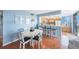Comfortable dining area featuring a white table and chairs next to breakfast bar and living area at 6051 Sun Blvd # 504, St Petersburg, FL 33715