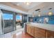 Bright kitchen with breakfast bar and sliding glass doors leading to a balcony with scenic views at 6051 Sun Blvd # 504, St Petersburg, FL 33715