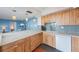 Bright kitchen with light wood cabinets, stainless steel appliances, and a breakfast bar overlooking the living area at 6051 Sun Blvd # 504, St Petersburg, FL 33715