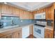 Bright kitchen featuring light wood cabinets, modern appliances, and stylish subway tile backsplash at 6051 Sun Blvd # 504, St Petersburg, FL 33715