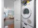 Image looking from bunk room into a laundry room with a stacked washer and dryer at 6051 Sun Blvd # 504, St Petersburg, FL 33715