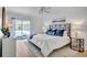 Bright main bedroom with a king bed, stylish décor, and sliding glass door to the screened pool at 11624 Monette Rd, Riverview, FL 33569
