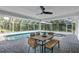 The screened-in pool features a spa, outdoor dining area, and lush landscaping, perfect for relaxation at 11624 Monette Rd, Riverview, FL 33569