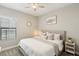 Bright bedroom featuring a neutral palette, soft bedding, and a ceiling fan at 14838 Paddock Pond Ave, Lithia, FL 33547