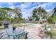 Spacious backyard featuring a patio, dining area, barbecue grill, and inviting pool, perfect for outdoor entertaining and relaxation at 1744 Colmar Dr, Holiday, FL 34690