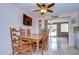 Cozy dining area featuring wood table and chairs and view of outdoor living at 1744 Colmar Dr, Holiday, FL 34690