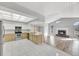 Open kitchen with stainless appliances flows into the cozy living room with a brick fireplace at 1803 Tawnee Pl, Brandon, FL 33510