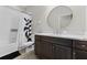 Bathroom featuring a shower and tub, plus a vanity with a circular mirror at 29913 Southwell Ln, Wesley Chapel, FL 33543