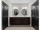 Bright bathroom with dual vanities, round mirrors, and ample storage space at 29913 Southwell Ln, Wesley Chapel, FL 33543