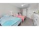 Bedroom featuring two beds, ceiling fan and closet, perfect for children at 29913 Southwell Ln, Wesley Chapel, FL 33543