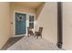 Cozy front porch with decorative wreath, outdoor seating, and a welcoming autumn sign at 29913 Southwell Ln, Wesley Chapel, FL 33543