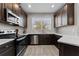 Well-equipped kitchen with stainless steel appliances, dark cabinets, and bright white countertops at 29913 Southwell Ln, Wesley Chapel, FL 33543