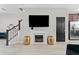 Cozy living room showcasing a modern fireplace, mounted television, and convenient access to the kitchen at 29913 Southwell Ln, Wesley Chapel, FL 33543