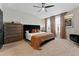 Comfortable main bedroom with a ceiling fan, neutral color palette, and large windows at 29913 Southwell Ln, Wesley Chapel, FL 33543
