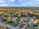 Expansive aerial view of a community, highlighting the lush landscaping and serene environment, under a blue sky at 3870 155Th E Ave, Parrish, FL 34219