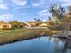 Large backyard with white fence, lawn, lake, and mature trees, perfect for outdoor activities at 3870 155Th E Ave, Parrish, FL 34219