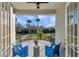 Balcony furnished with wicker chairs and a scenic view of lush foliage at 3870 155Th E Ave, Parrish, FL 34219