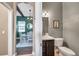 Cozy half bath with a decorative mirror and adjacent dining room with dark wood beams and a table setting at 3870 155Th E Ave, Parrish, FL 34219