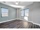 Empty bedroom with gray walls, wood-look flooring, and two windows providing natural light at 3870 155Th E Ave, Parrish, FL 34219