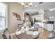 Charming dining area with white cabinets, a stylish light fixture, and views into the kitchen at 3870 155Th E Ave, Parrish, FL 34219