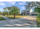 Two-story home with a well-manicured lawn, palm trees, and a spacious driveway leading to a two-car garage at 3870 155Th E Ave, Parrish, FL 34219