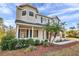 Charming two-story home with blue shutters, lush landscaping, and a side entry garage at 3870 155Th E Ave, Parrish, FL 34219