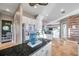Open kitchen with white cabinets, stainless steel appliances, and a breakfast bar overlooking the living area at 3870 155Th E Ave, Parrish, FL 34219