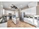 A spacious kitchen featuring white cabinets, stainless steel appliances, and dark granite countertops at 3870 155Th E Ave, Parrish, FL 34219