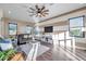 Bright living room featuring a ceiling fan, stylish striped walls, and natural light from the black-framed windows at 3870 155Th E Ave, Parrish, FL 34219