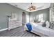 Cozy main bedroom with a tray ceiling, ceiling fan, whitewashed furniture, and modern decor at 3870 155Th E Ave, Parrish, FL 34219