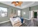 Comfortable main bedroom with a ceiling fan, whitewashed wood frame bed, and natural light at 3870 155Th E Ave, Parrish, FL 34219