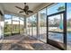 Screened patio with brick floors, ceiling fan and view of backyard pool and landscaping at 3870 155Th E Ave, Parrish, FL 34219