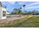 Backyard pool area with brick patio, palm trees, white picket fence, and view of lawn and trees at 3870 155Th E Ave, Parrish, FL 34219