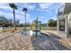 Backyard boasts a refreshing pool with a patio, framed by palm trees and a white picket fence at 3870 155Th E Ave, Parrish, FL 34219