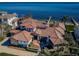 Stunning aerial view of a Mediterranean-style home on the water with a tiled roof and lush landscaping at 3901 Bayshore Ne Blvd, St Petersburg, FL 33703