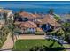Expansive waterfront home featuring lush landscaping, tile roof, and a paver driveway leading to stunning bay views at 3901 Bayshore Ne Blvd, St Petersburg, FL 33703