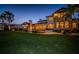 Expansive backyard with large home, including an outdoor kitchen, seating areas, pool and lush green lawn at 3901 Bayshore Ne Blvd, St Petersburg, FL 33703